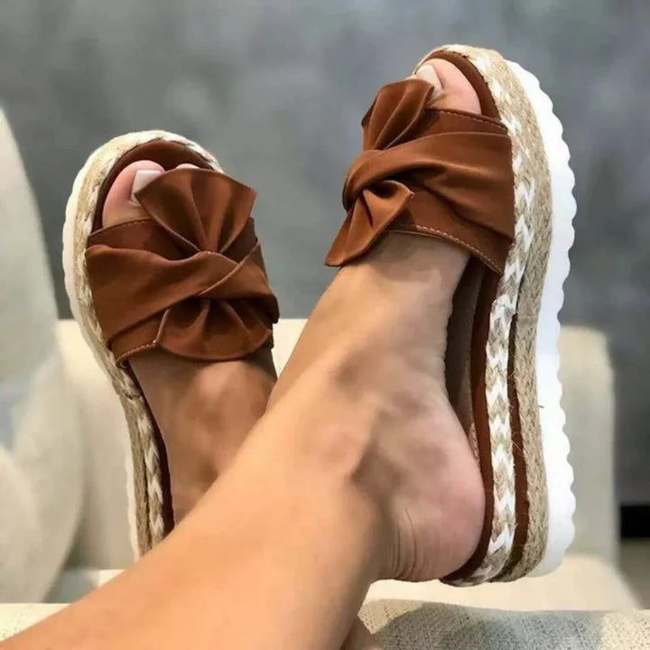 Fashionable women's platform sandals with a cute bow design, great for everyday outfits.