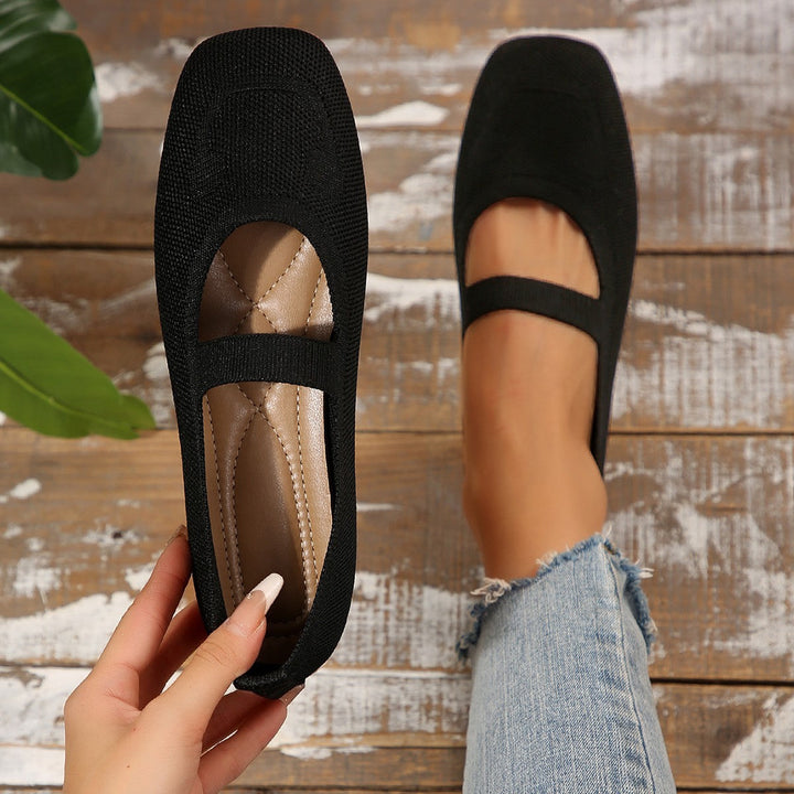 Women's playful Mary Jane ballet flats with unique smiling face detail, perfect for casual wear.