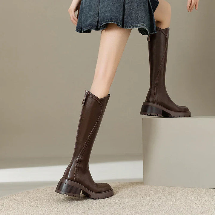 Pair of comfortable women's knee-high orthopedic leather boots, ready for cold weather.