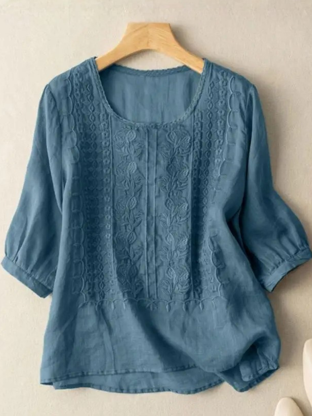 Comfortable women's relaxed fit blouse featuring three-quarter sleeves and delicate embroidery for summer style.