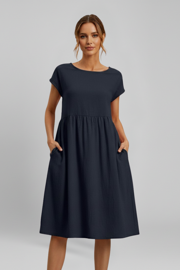 Versatile women's everyday dress, knee-length, relaxed fit, featuring short sleeves and convenient pockets.