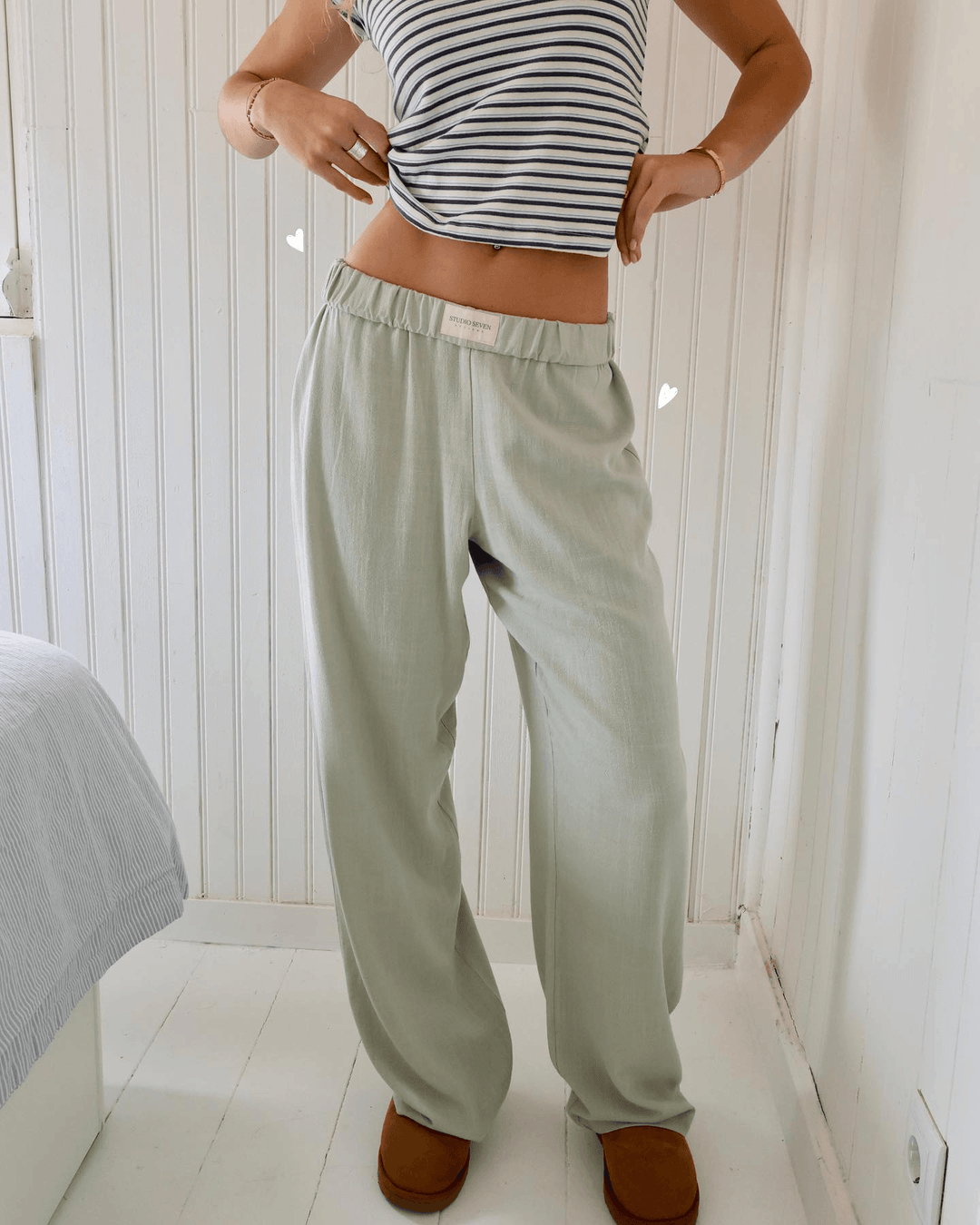 White women's relaxed lounge pants, lightweight & soft with elastic waist, perfect for casual comfort.