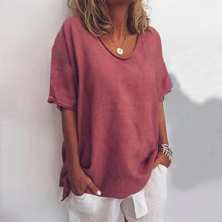 Comfortable women's relaxed V-neck tunic blouse with elbow sleeves, versatile for casual summer outfits.