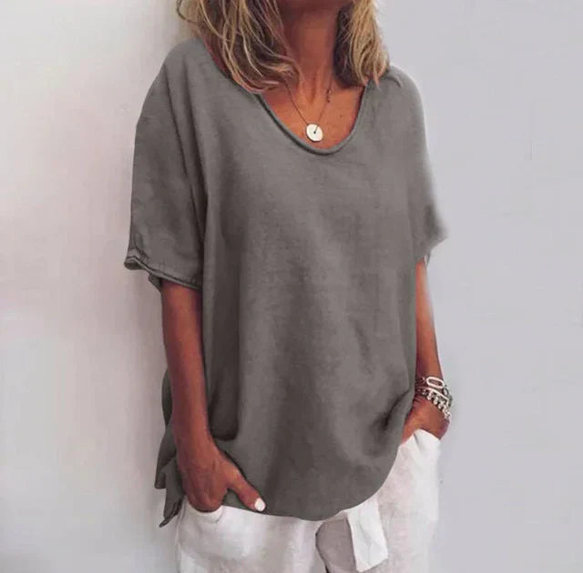 Soft women's V-neck blouse, relaxed fit with elbow sleeves, ideal for comfortable summer everyday fashion.