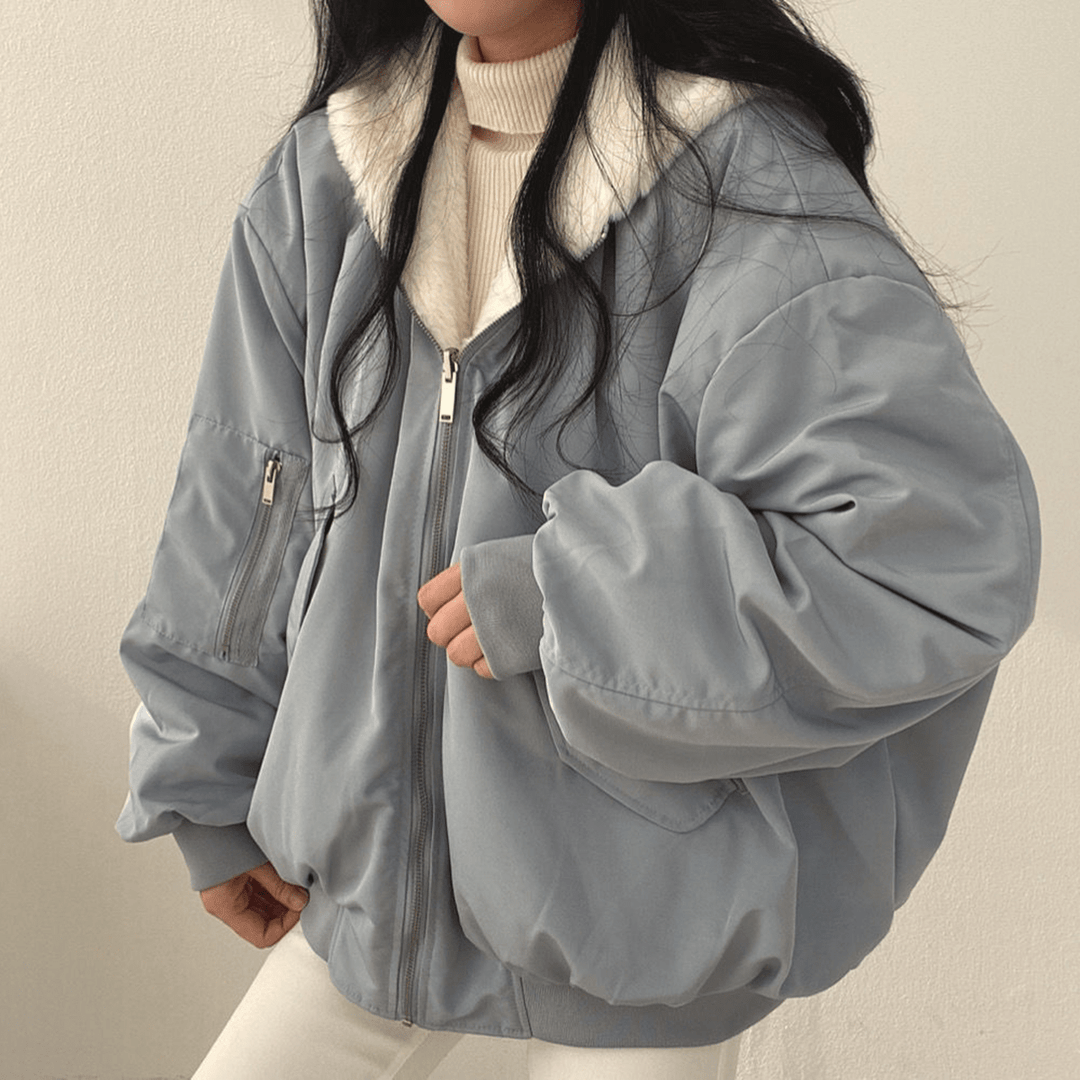Women's relaxed fit warm winter jacket in classic black, front view with zipper closure and pockets.