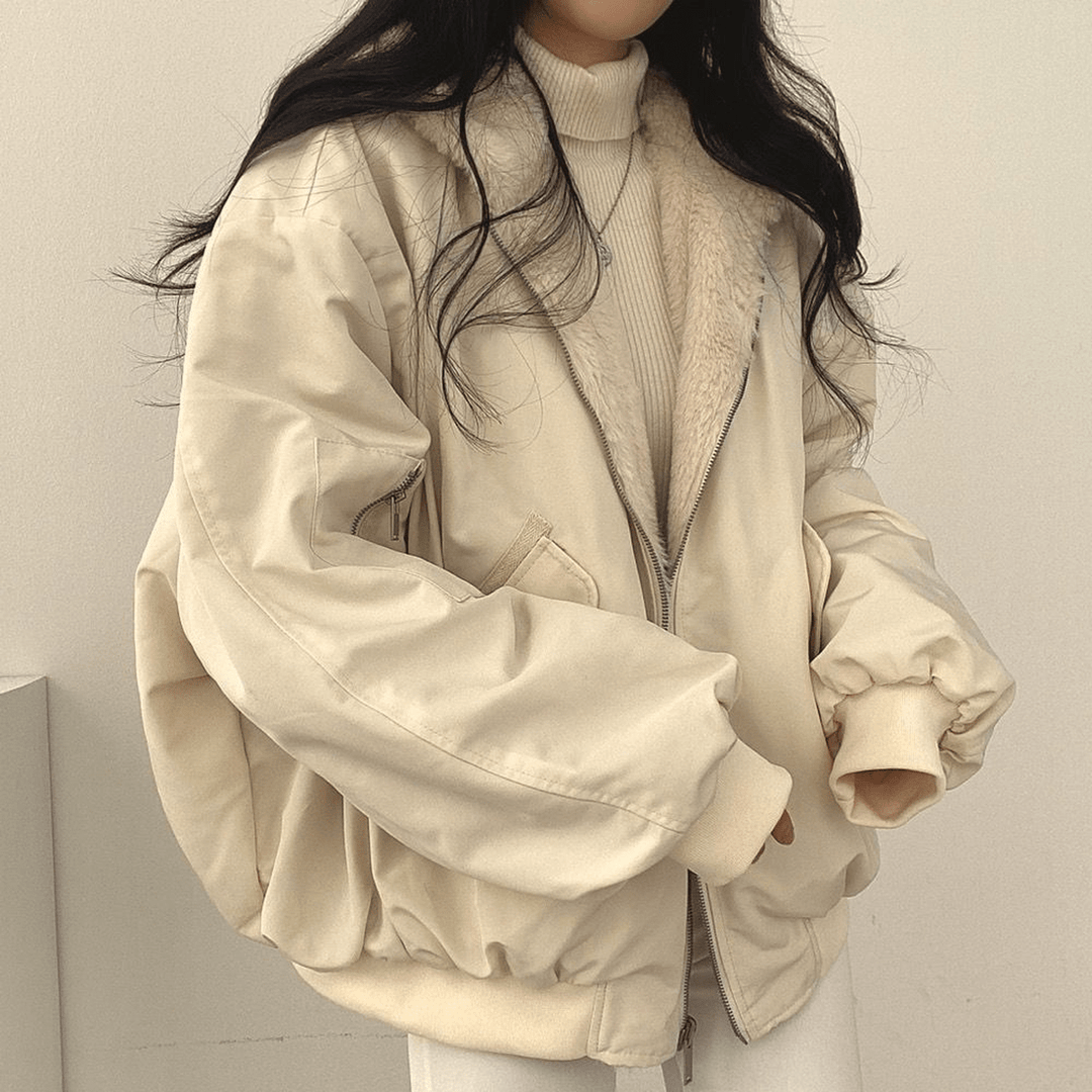 Model wearing a grey oversized winter jacket for women, showcasing its relaxed fit and stylish look.