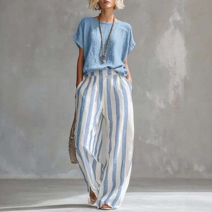 Chic women's linen blend two-piece beachwear set: wide-leg pants with elastic waist & short-sleeve top. Resort wear.