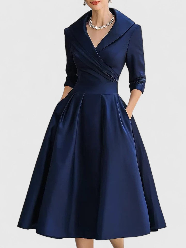 Women's formal wedding guest midi dress. Stylish ruched A-line design with a flattering wrap collar & 3/4 sleeves.