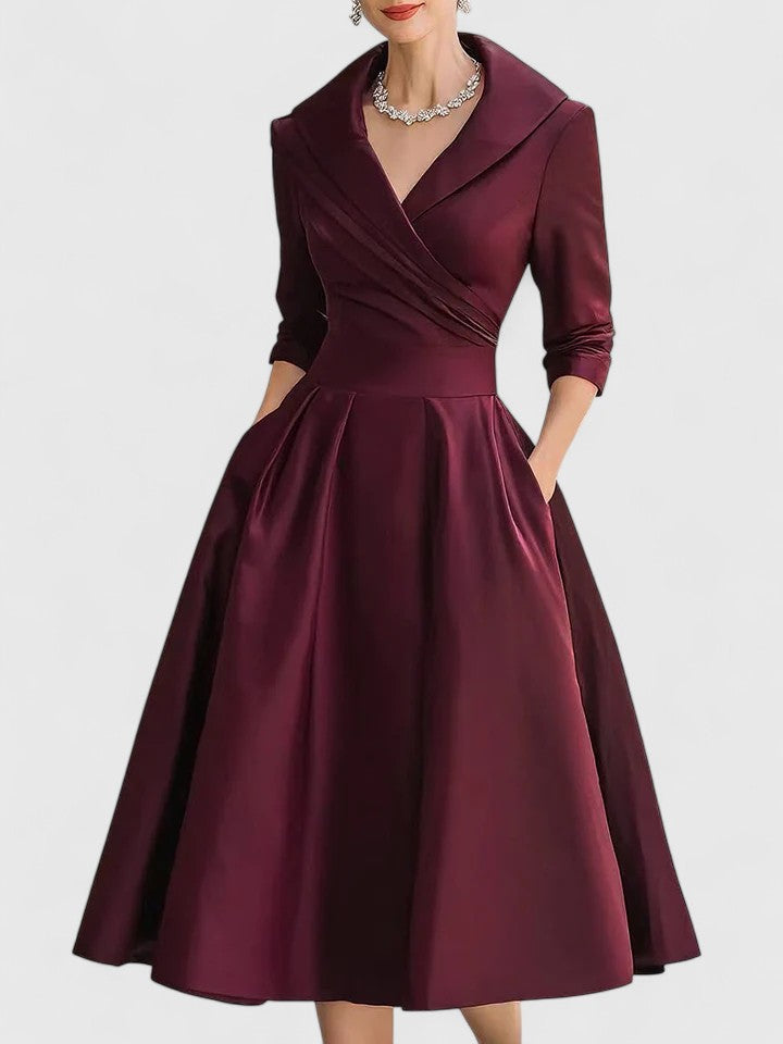 Party-ready women's ruched A-line midi dress. Features a chic wrap collar & three-quarter sleeves. Elegant occasion wear.