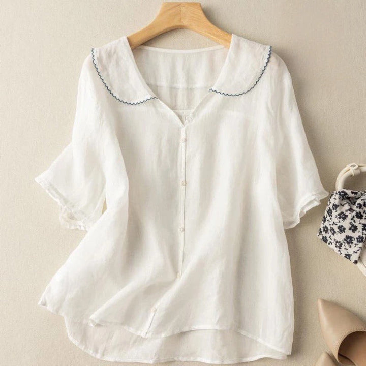 Relaxed fit women's button-front blouse with scalloped collar and short sleeves. Perfect casual chic for spring/summer.