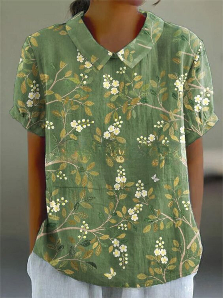 Beautiful women's floral print short sleeve blouse, a vibrant and elegant top for warm weather.