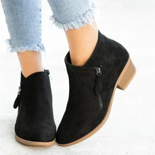Orange fashion ankle boots for women. Trendy pointed toe, block heel, and side zip. Stylish casual footwear.