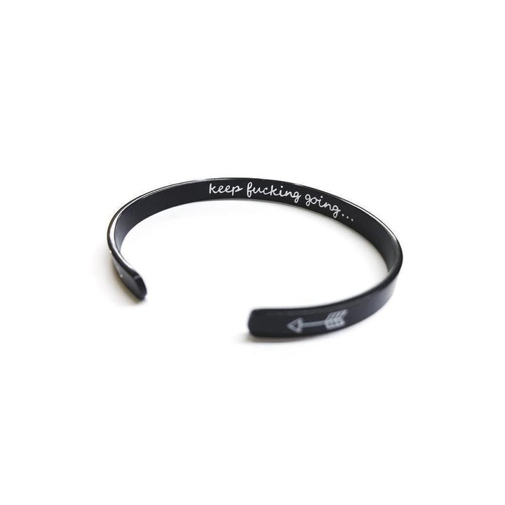 Closeup of engraved message on a silver women's cuff bangle, motivational jewelry