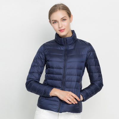 Detail of a women's slim fit insulated puffer coat zipper and pocket, indicating quality outerwear.