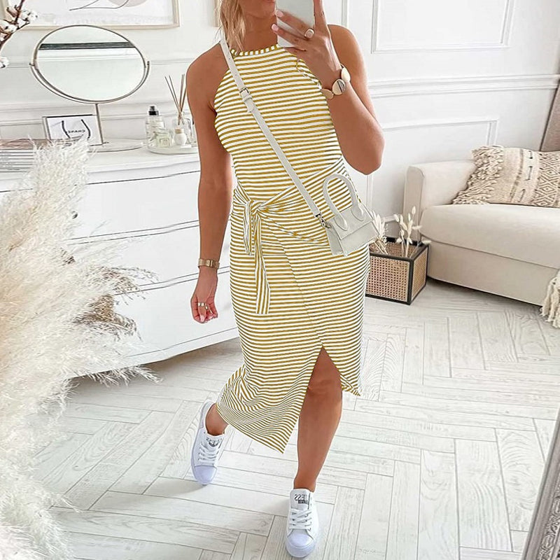 Model wearing a sleeveless women's striped halter neck dress, highlighting its flared summer style.