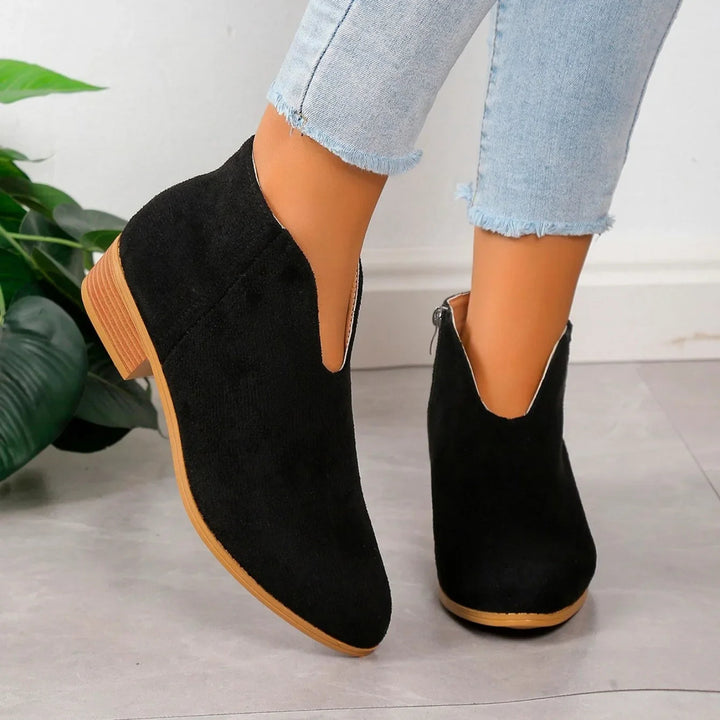 Side view of women's leopard print ankle boots, showcasing the elegant silhouette and functional zipper.