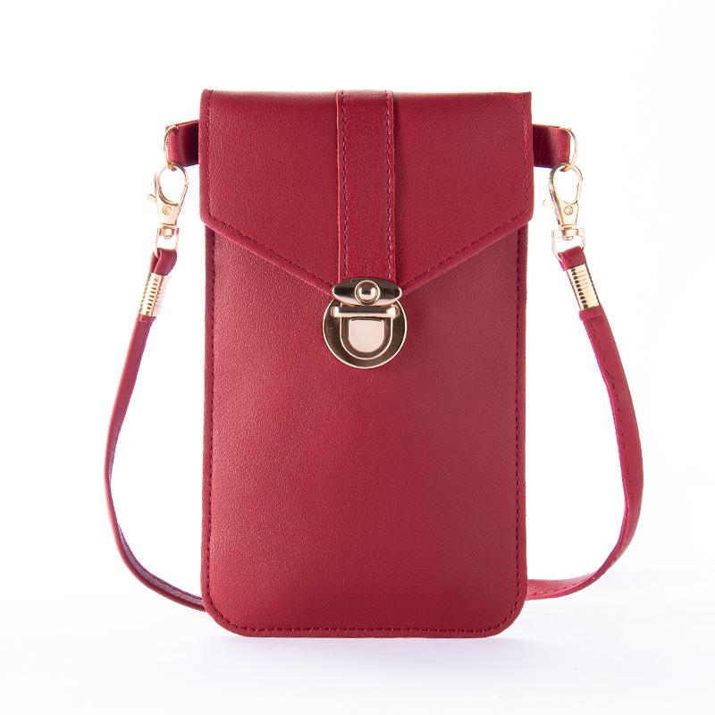 Hands-on image of a women's touchscreen crossbody phone bag, demonstrating screen access
