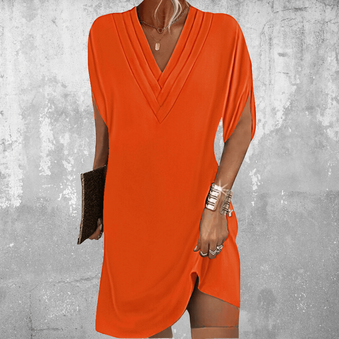 Close-up: Detail of soft, comfortable fabric on a women's tummy covering midi dress, highlighting quality & drape.