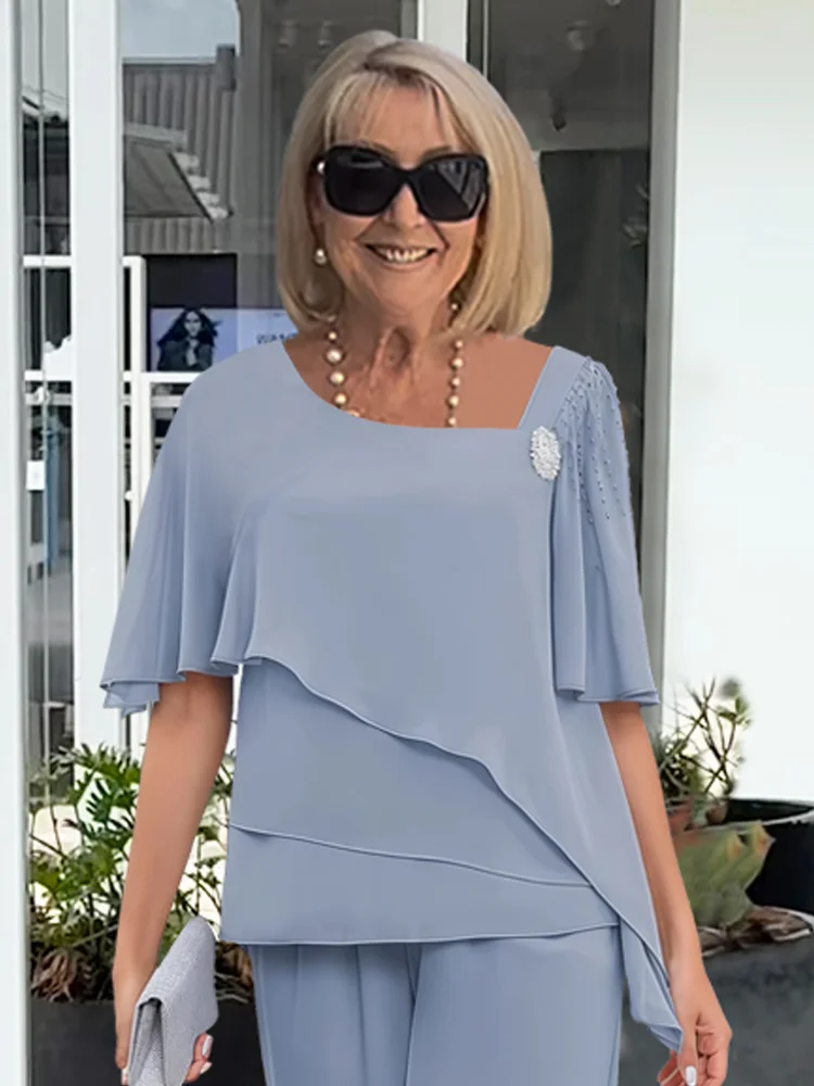 Stylish women's two-piece outfit with short sleeve top & straight leg pants. Coordinated set for comfortable summer fashion.