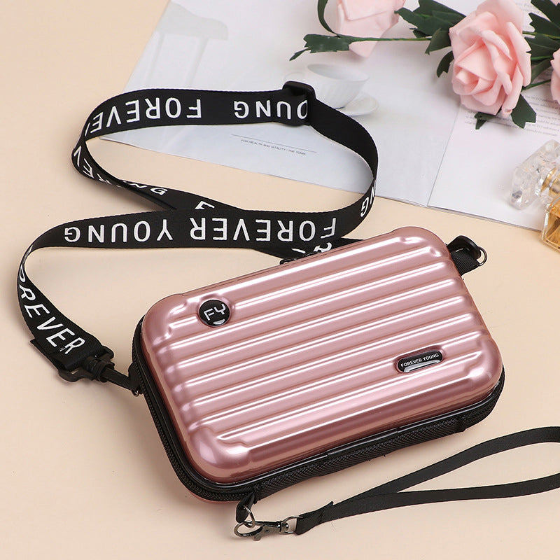 Women's unique mini suitcase crossbody bag with a playful, yet sophisticated design