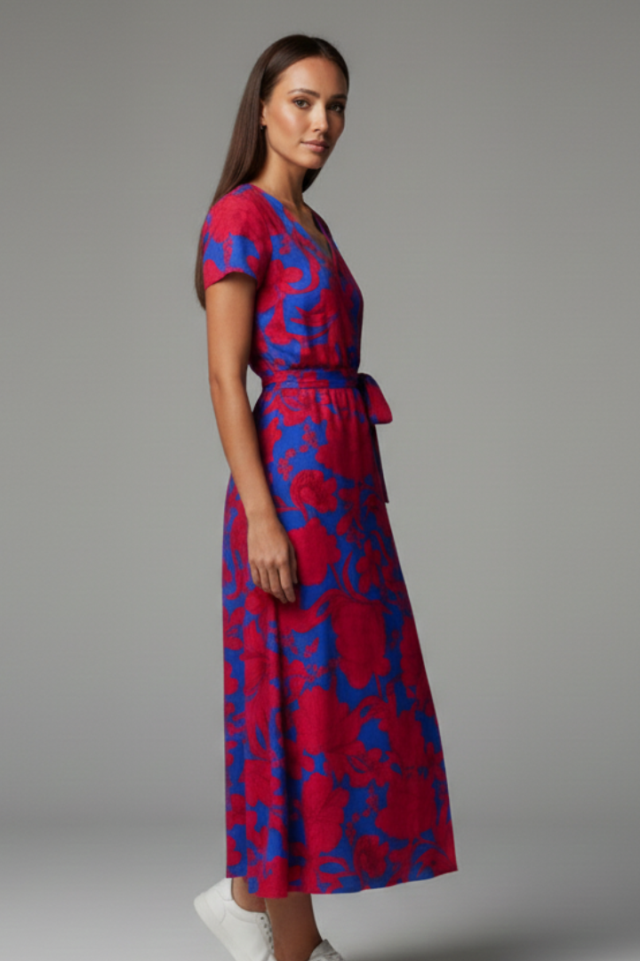 Women's patterned V-neck summer dress with short sleeves and a flowing flared skirt.