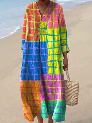 Elegant women's maxi dress featuring unique vibrant patchwork print. Long sleeve V-neck for stylish casual wear.