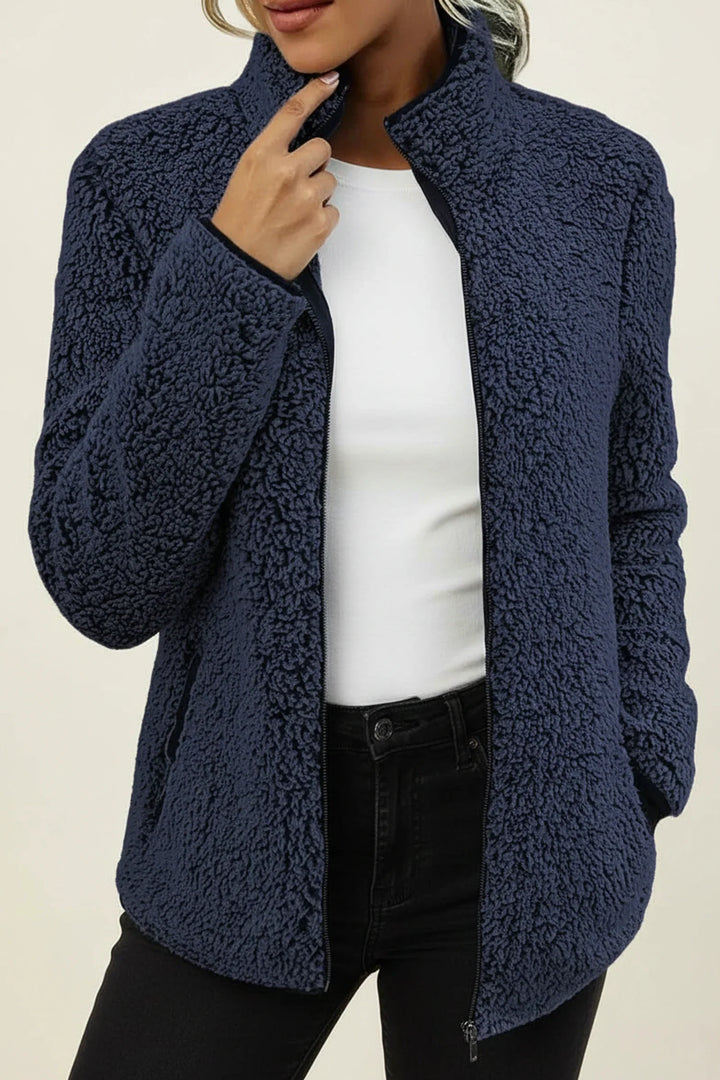 Relaxed fit women's cozy winter jacket, zip-up style, great for casual everyday outerwear and warmth.