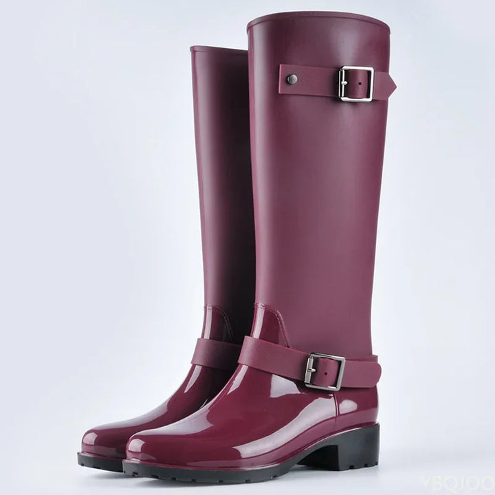 Fashionable women's knee-high rain boots featuring adjustable buckles and sturdy block heels.