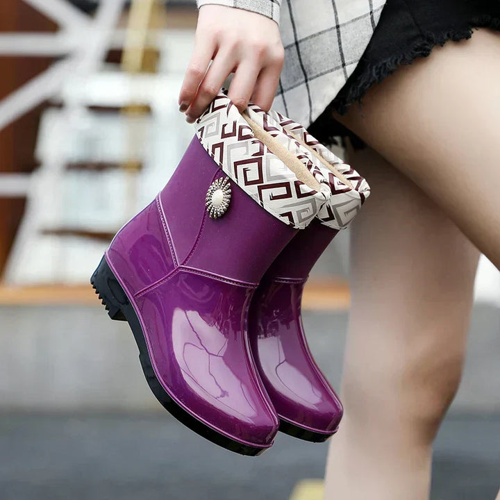 Fashionable waterproof women's rain boots with a vibrant floral detail and practical treaded sole for wet conditions.