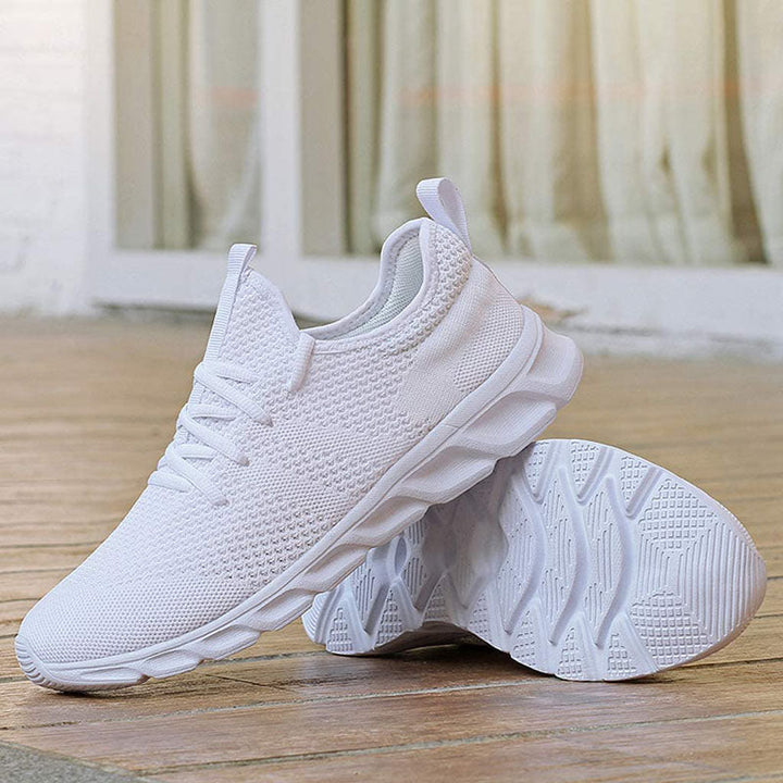 Women's white breathable lace-up trainers, ideal for everyday wear and walking, showing side profile